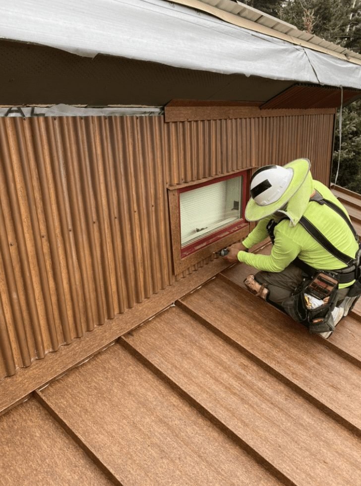 McPartlon Roofing crew installing metal siding and roofing