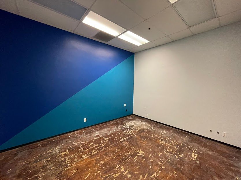 Commercial office interior with a two tone blue geometric accent wall